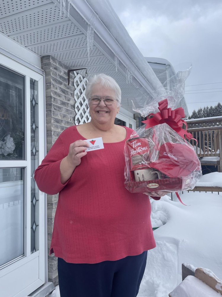 Runner-up quiz winner Janet Kyer with her prizes of a $25 Gift Card & Coffee Basket, courtesy of Canadian Tire and Tim Hortons.