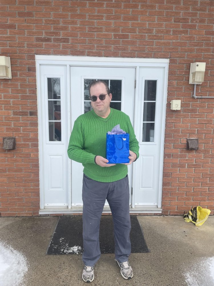 Attendance-winner Mark Ploeg with his prize of a Men’s Care Package, courtesy of ELNOS.